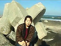 Asian girl plays and pees at the beach