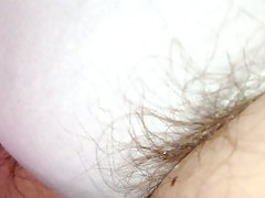 close up shot of long hairs escaping from white pantys,