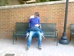 Students humping on a bench in public