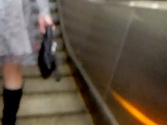 Girl in stockings on metro escalator 