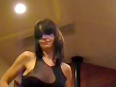 Masked milf dances and plays with her pussy