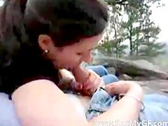 Couple outdoors while the girl sucks him