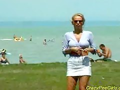 Crazy pee girl on the beach 