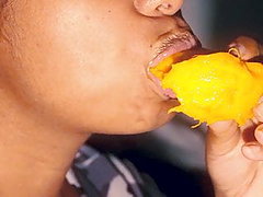 Sexy mouth ebony playing with a mango
