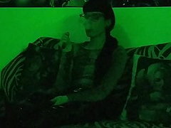 Sexy goth domina smoking in mysterious green 