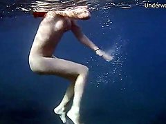 Naked redheaded beauty swims in the ocean 