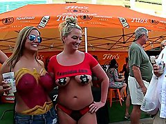 Body painted beauties playing at a street fair 