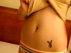 Hot brunette chick shows her navel piercing and tattoo