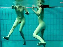 Two nude hotties swimming and touching 