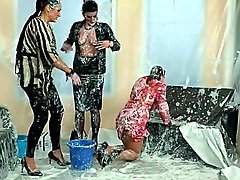 Three women completely covered in messy goo 