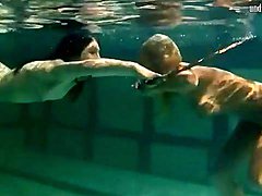 Underwater girls play with a h