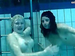 Two naked young chicks swim in