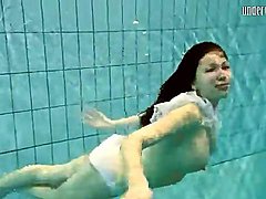 Girl in white panties swims in pool