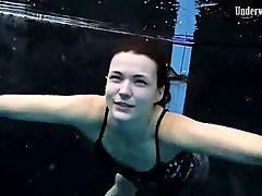 Beautiful girl swims and smiles underwater 