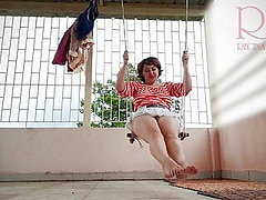Depraved housewife swinging without panties on a swing 