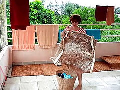 Naked laundry The maid is drying clothes in the laundry 