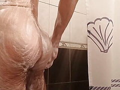 Hairy guy lathering himself in the shower 