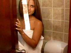 Tanned beauty is posing naked in the bathroom 