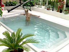 Hot blonde milf gets naked in the pool and uses a dildo